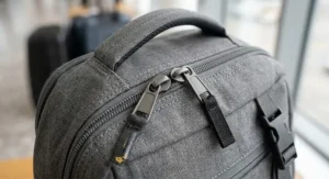 Close up shot of the durable zippers and heavy duty fabric on a Ryanair cabin bag rucksack.