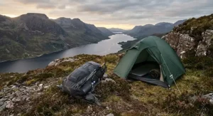 A lightweight 40l rucksack resting next to a small tent during a wild camping trip in the Scottish Highlands