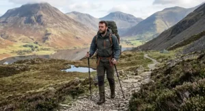 A hillwalker trekking through the Scottish Highlands with a lightweight 70l hiking rucksack, illustrating comfortable load distribution.