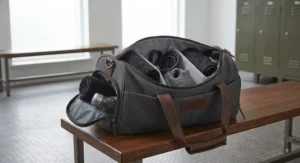 Designer duffle gym holdall bag packed with sports gear and a water bottle