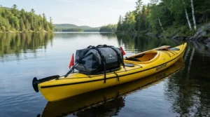 Securing the best waterproof holdall configured as a water-resistant duffel bag on a kayak deck