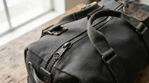 Close-up view of reinforced stitching and carrying handles on a foldable lightweight holdall