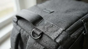 Close-up showing the reinforced handle of a high-quality laptop bag for commuting.